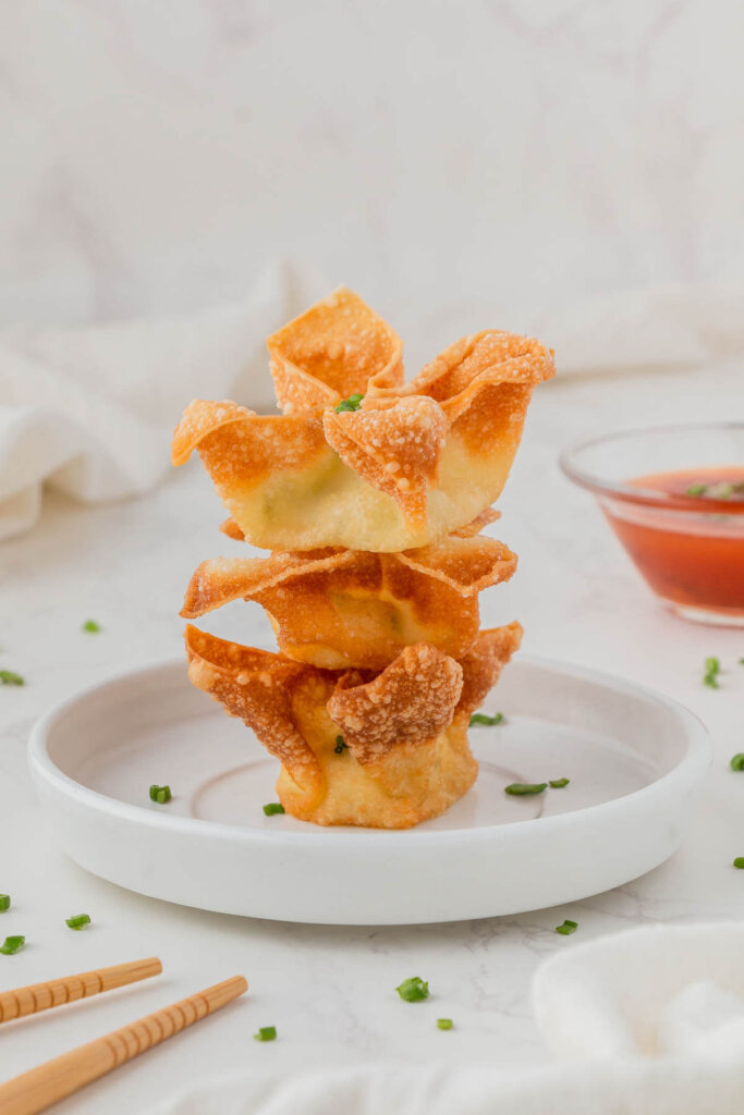 Panda Express Cream Cheese Rangoons stacked on top of each other on white place