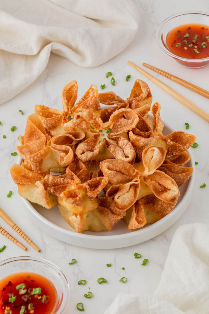 fried copycat Panda Express cream cheese rangoons with chop sticks and sauce in background