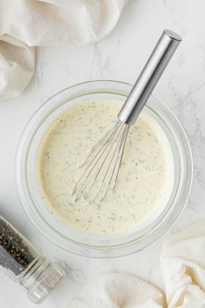 overhead view of Chili's Ranch in a clear bowl with metal whisk