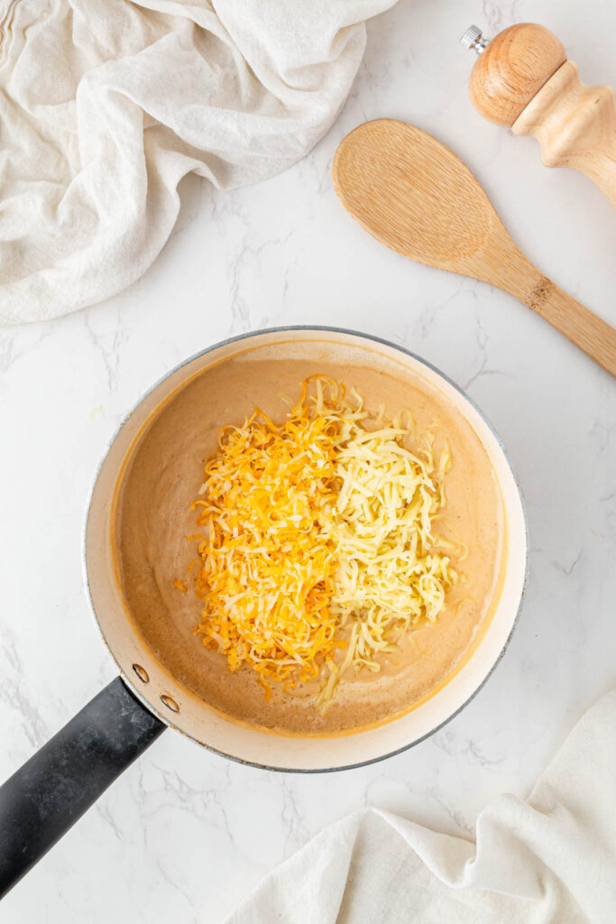 Adding shredded cheese to the roux