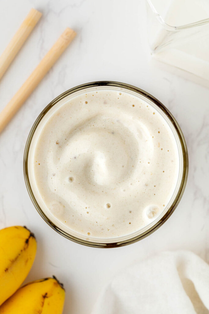 overhead view of banana boat smoothie in clear glass