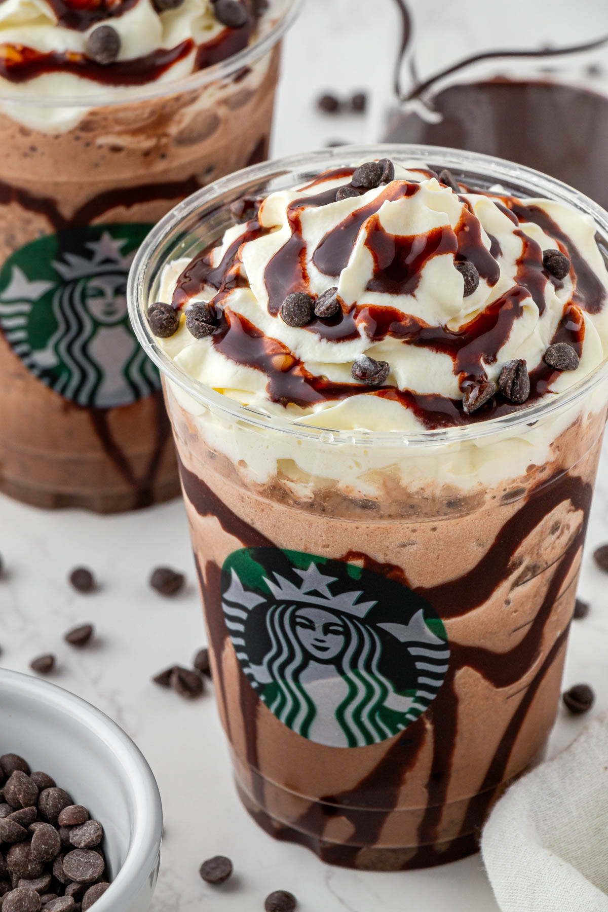 side view of double chocolate chip Frappuccino with whipped cream and chocolate drizzle