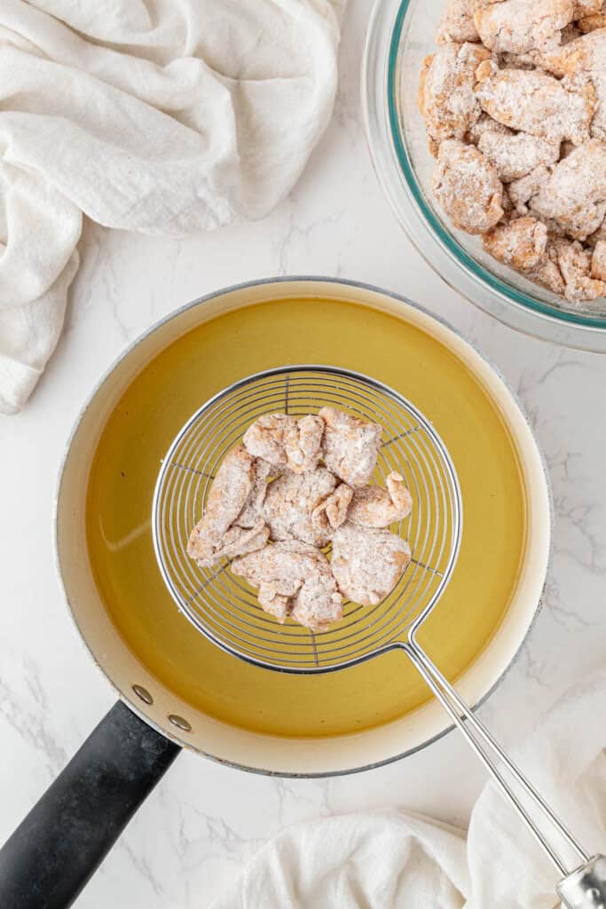 raw breaded chicken over the hot oil