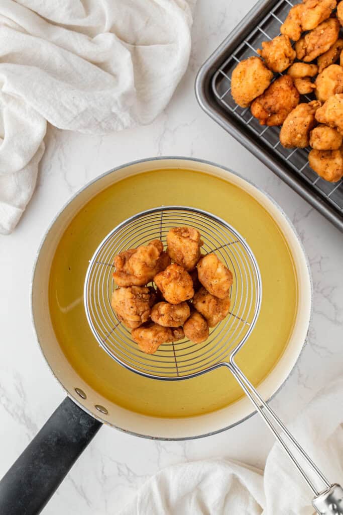 cooked chicken over the hot oil