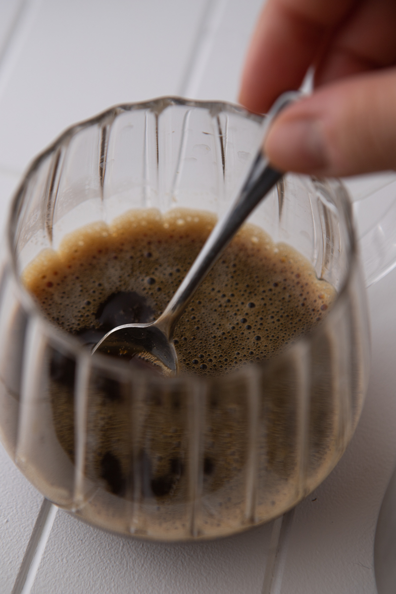 espresso and syrups being stirred with a spoon