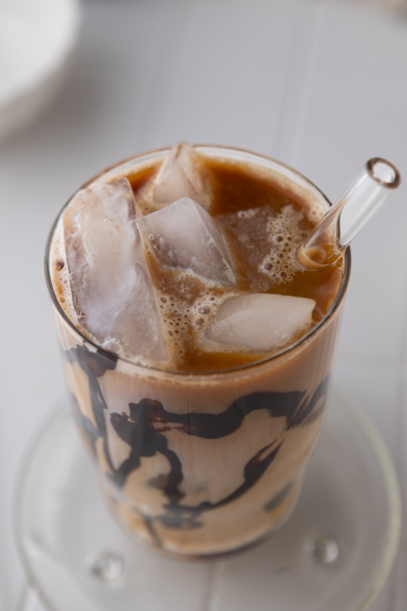 overhead shot of glass with unmixed coffee and cream