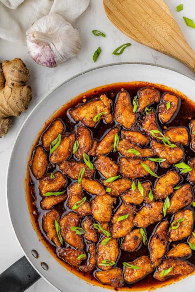 Panda Express bourbon chicken in skillet with green onions
