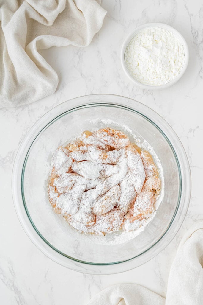 Chicken coated in cornstarch before pan frying