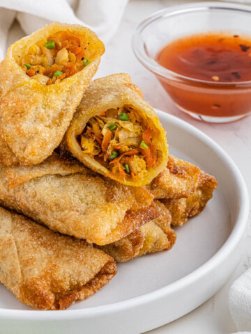 stack of panda express chicken egg rolls on white plate