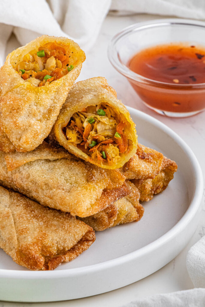 stack of panda express chicken egg rolls on white plate