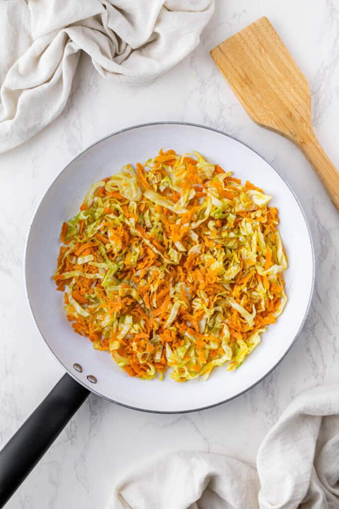 overhead view of uncooked panda express chicken egg roll filling in pan