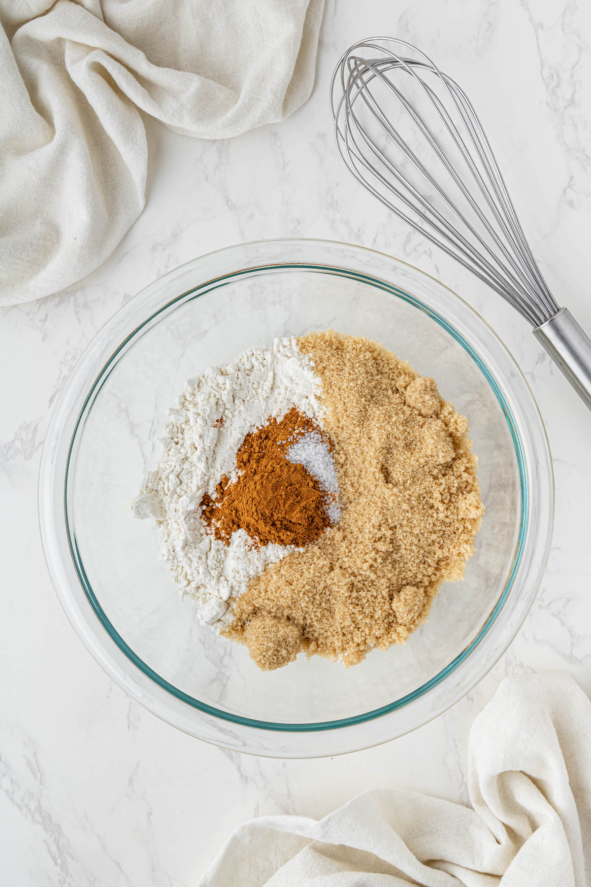 cinnamon streussel ingredients in a clear bowl with a whisk