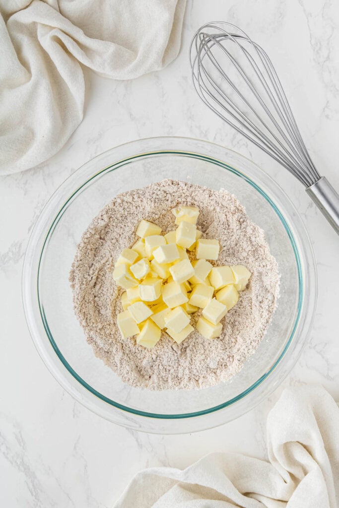 cinnamon streusel mix in clear bowl with butter cubes on top