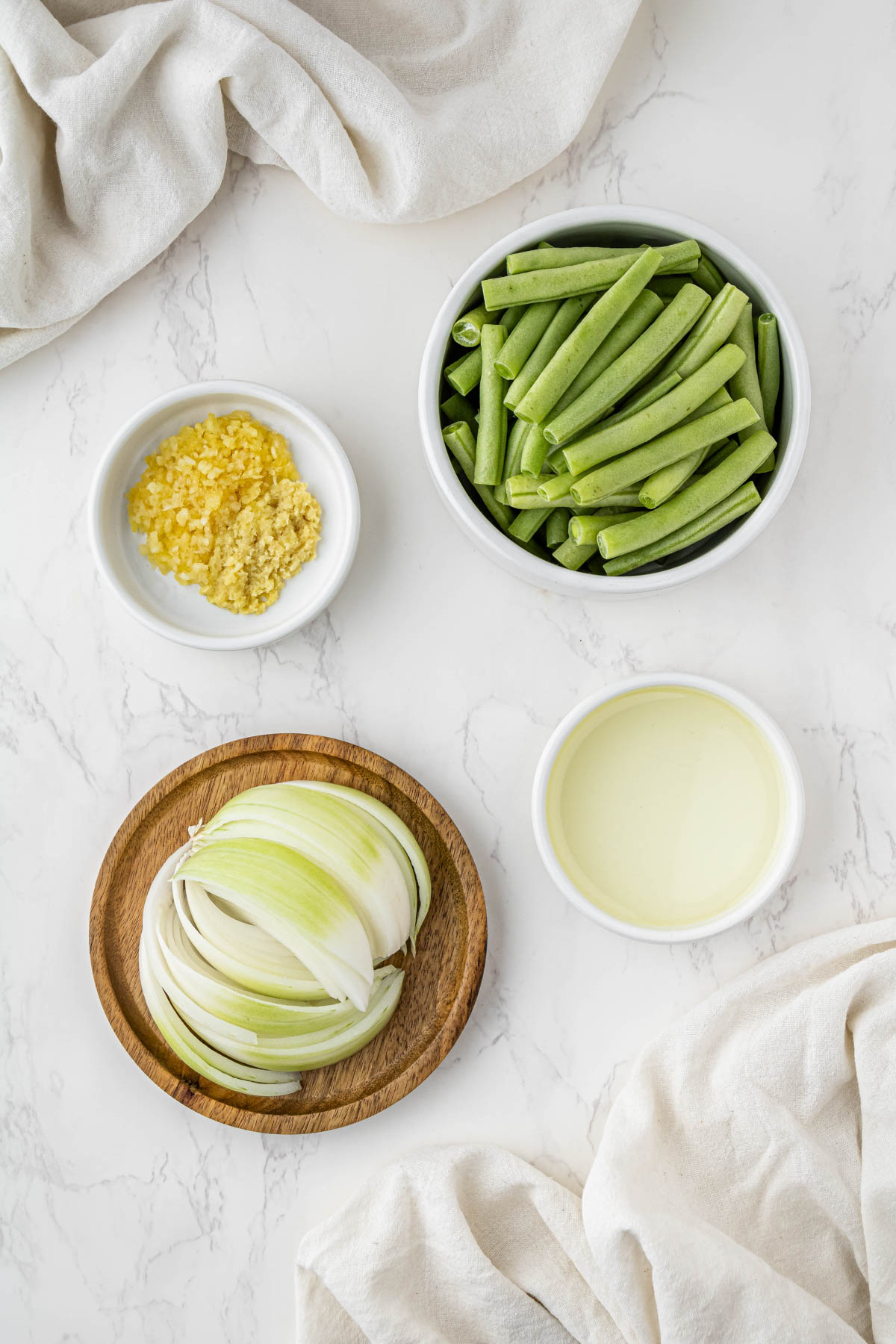 overhead view of string bean ingredients in bowls and spoons