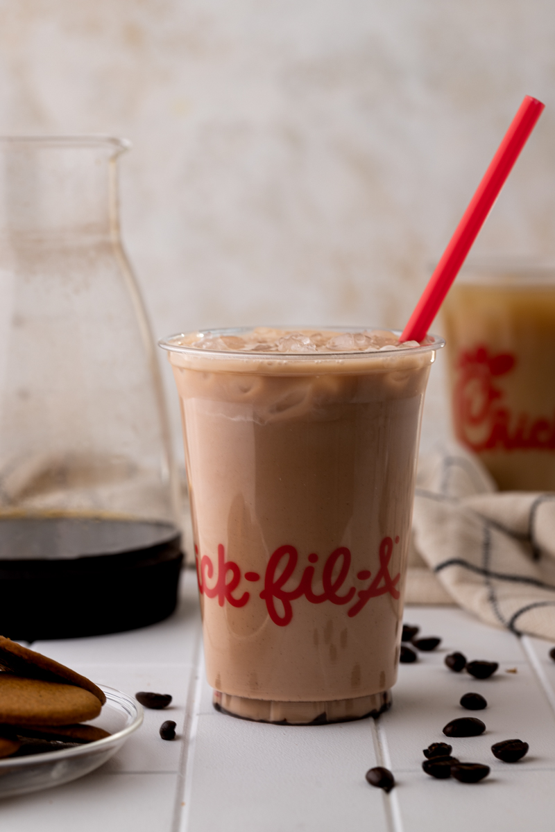 zoomed out shot of chick fil a mocha cold brew and cold brew coffee carafe.