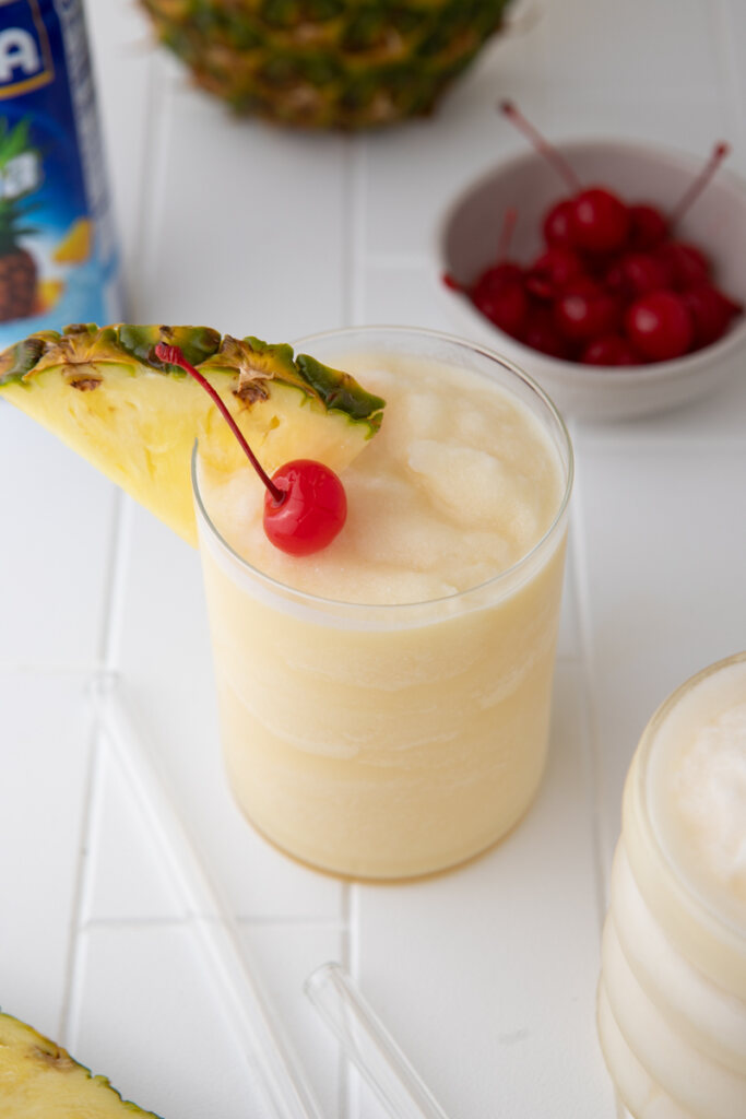 overhead view of topical Goya Pina colada with pineapple wedge and cherry wit