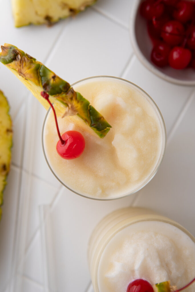 overhead view of topical Goya Pina colada with pineapple wedge and cherry