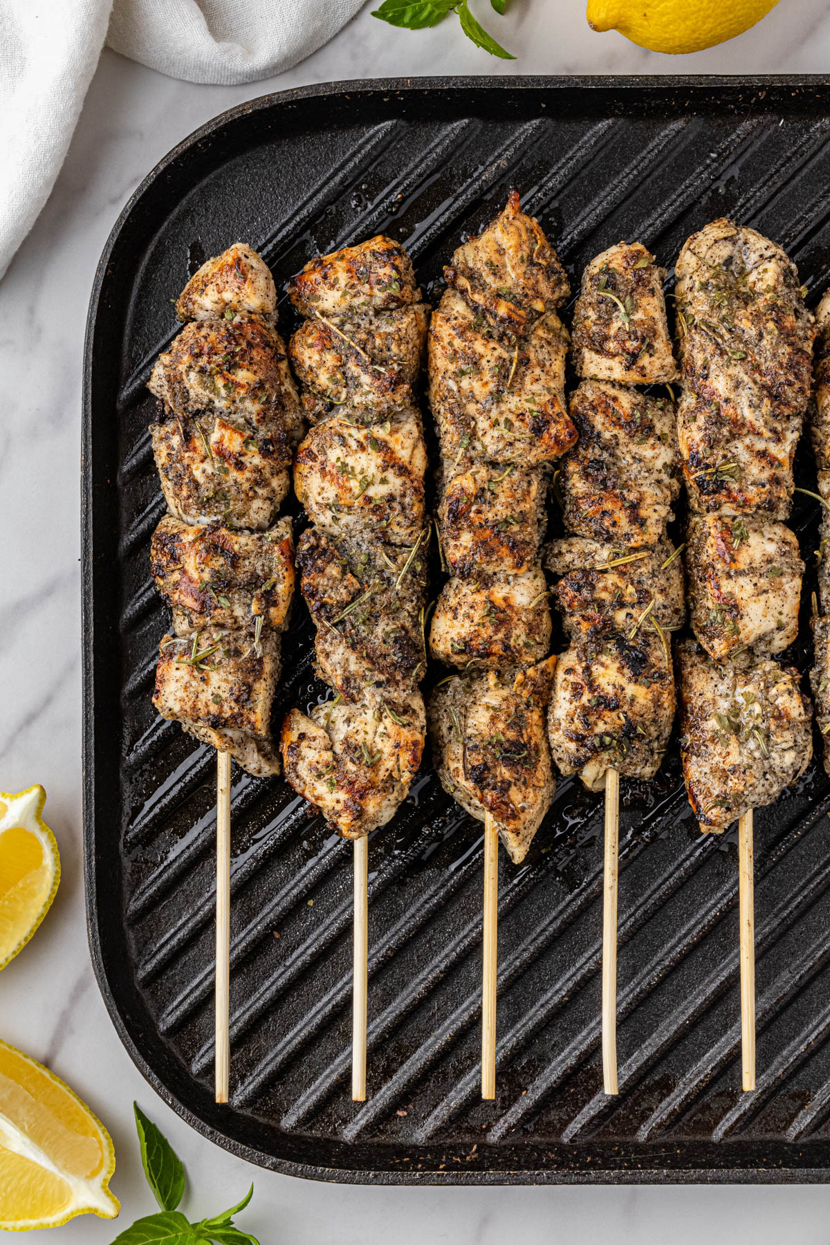 close up of costco chicken skewers recipe cooking on a cast iron skillet