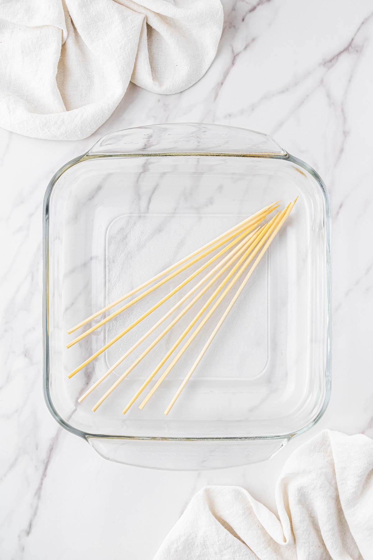clear dish with wooden sticks