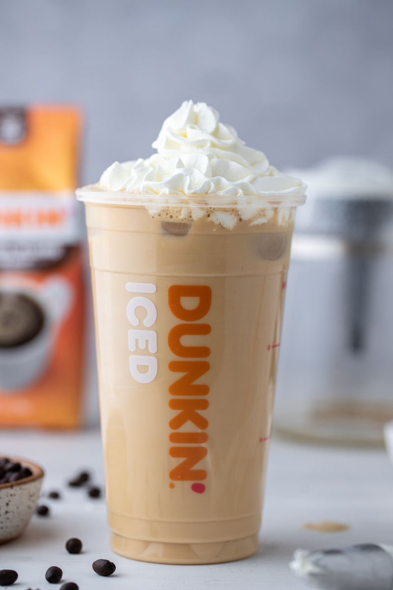 a dunkin donuts iced coffee with whipped cream on top