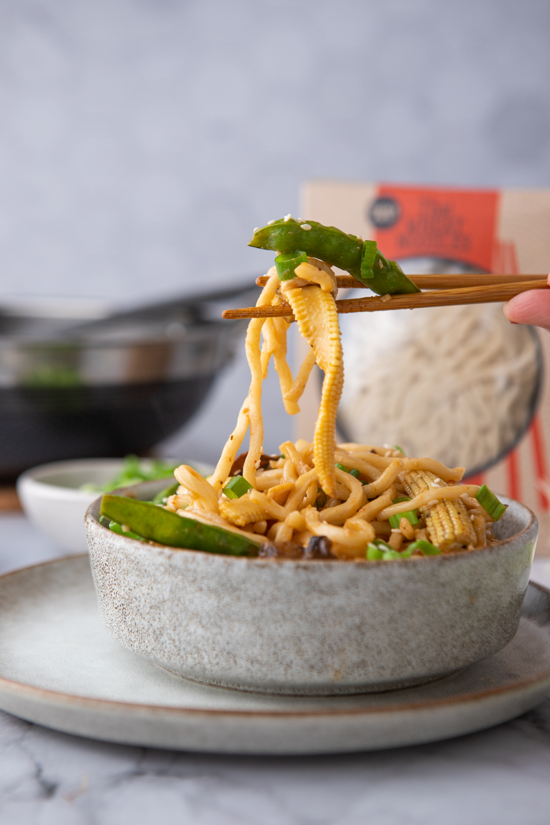 trader joe's thai wheat noodles being held up by chopsticks