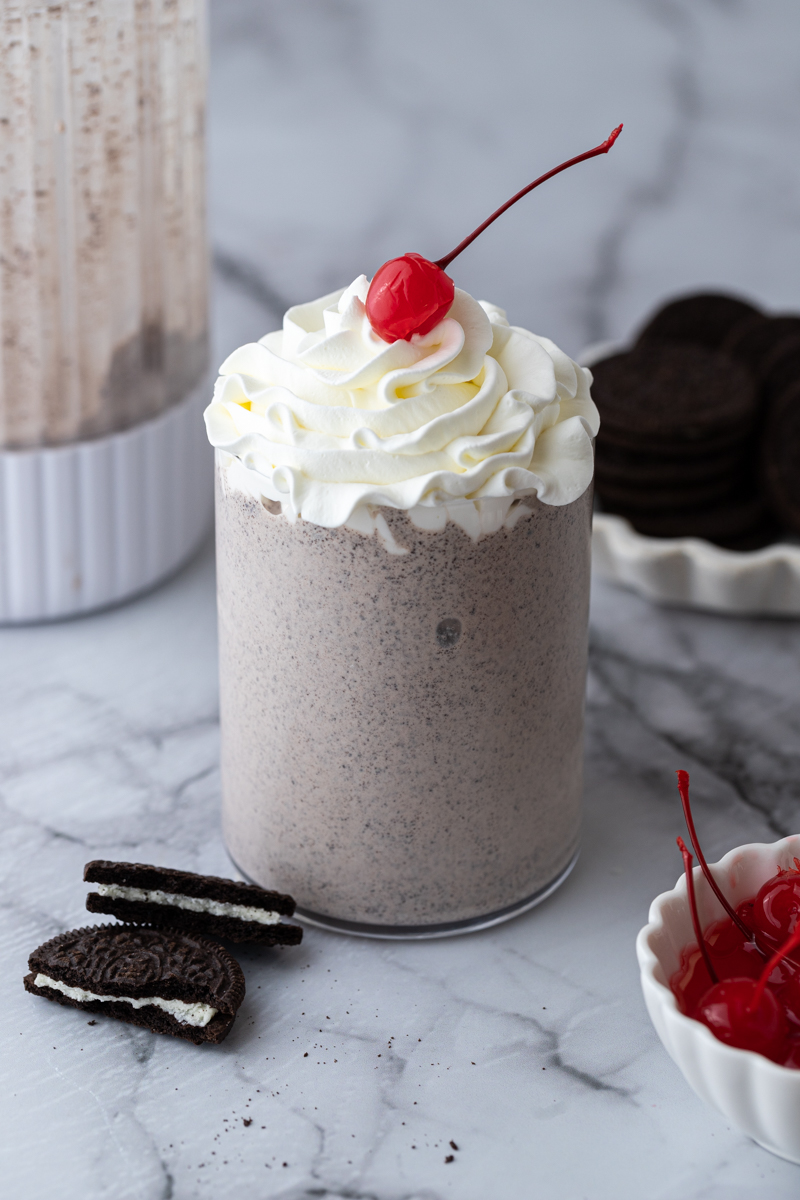 zoomed out shot of the chick-fil-a cookies and cream milkshake with ingredients around it