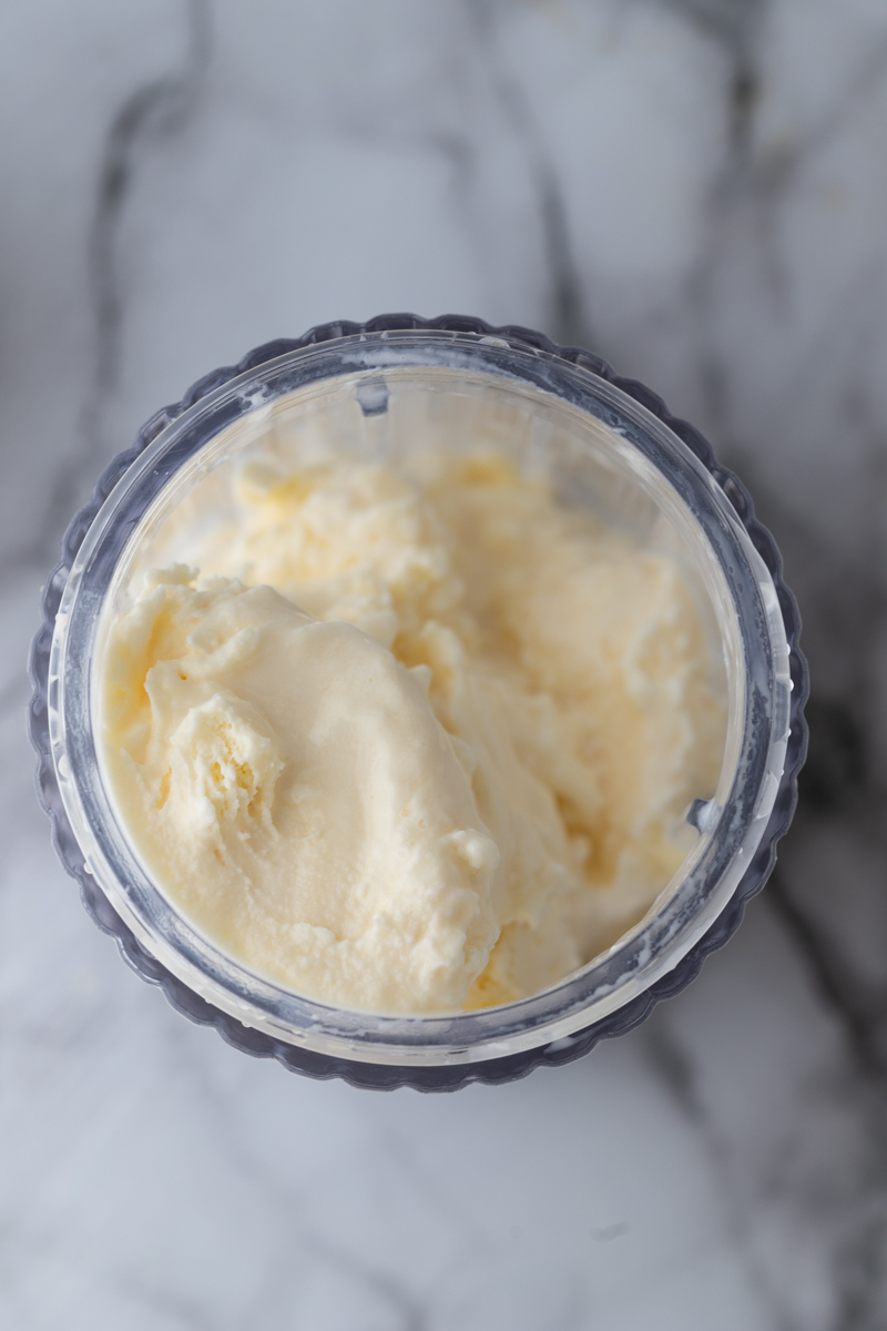 vanilla ice cream being put into a blender