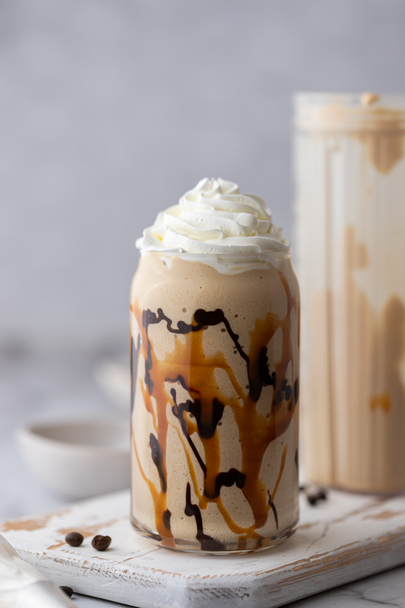 side shot of a blended coffee beverage with whipped cream on top