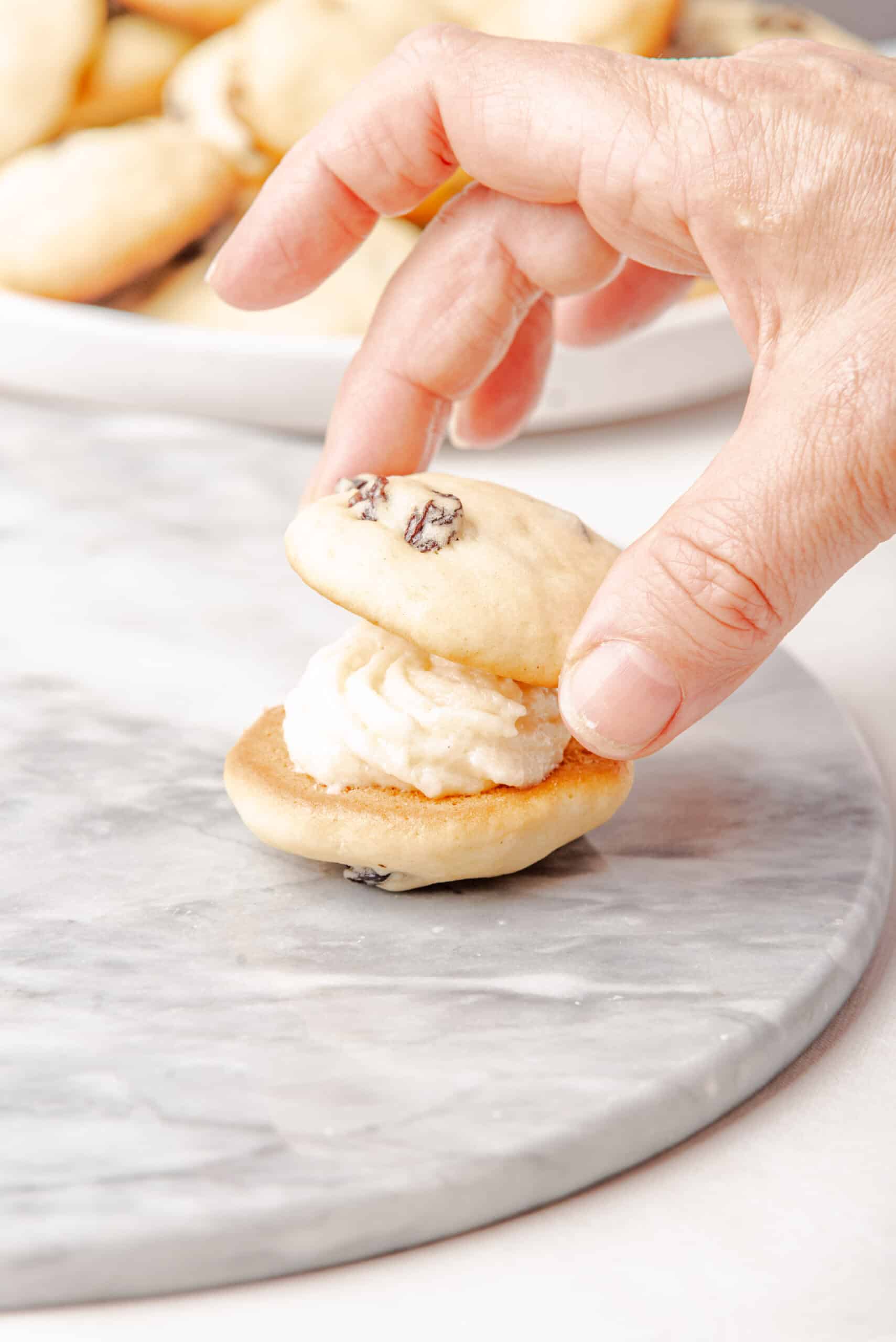 copycat Little Debbie Raisin Cream Pies getting assembled by hand