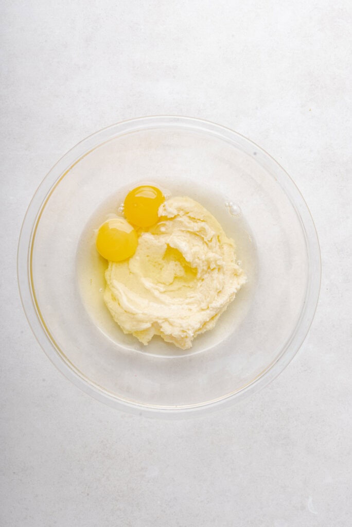 eggs and cookie dough mixture in clear bowl