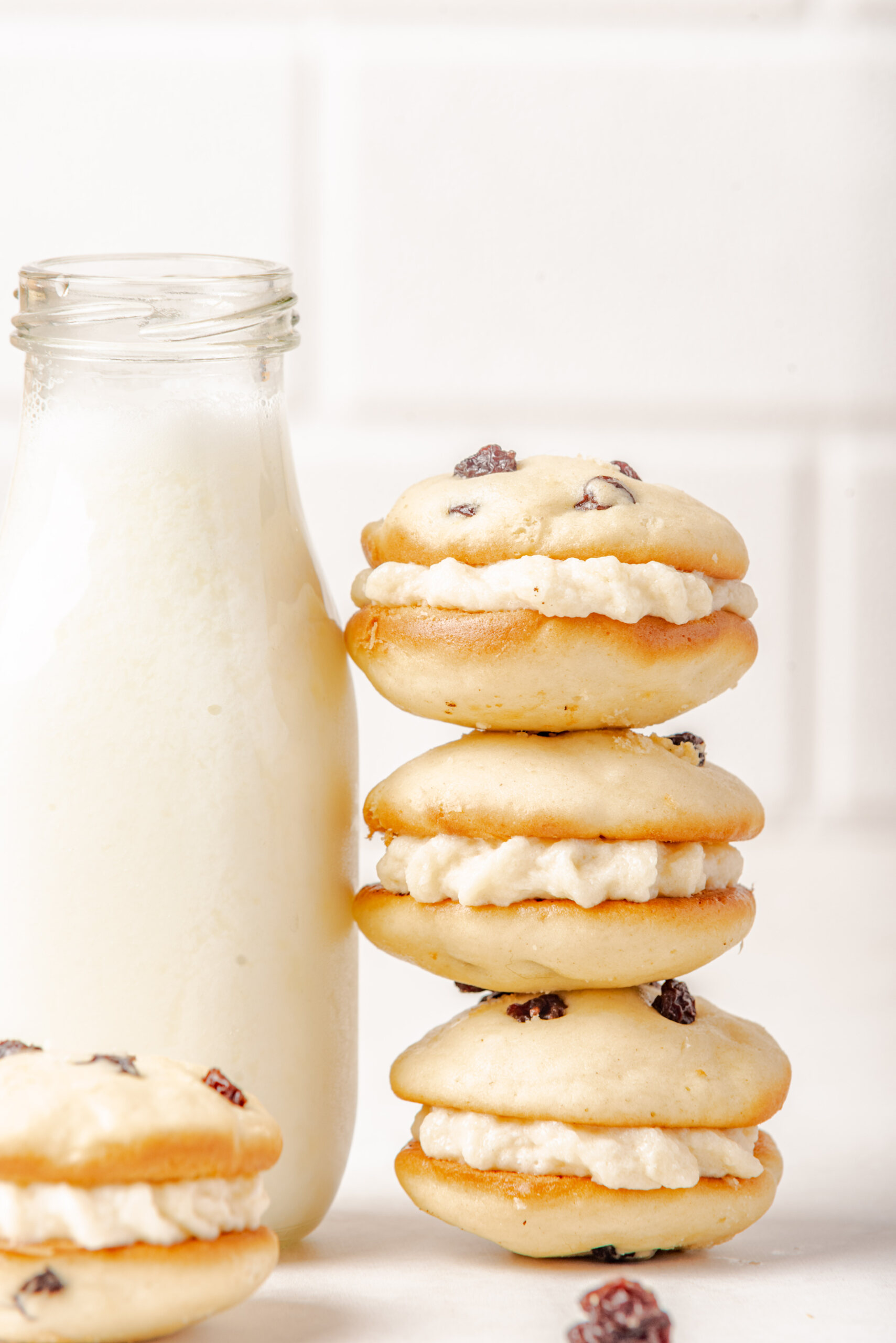 copycat Little Debbie Raisin Cream Pies in a stack leaning on milk
