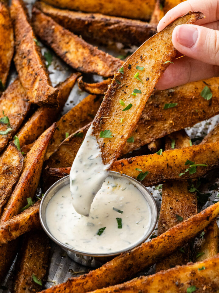 copycat buffalo wild wings potato wedges being dipped into a ranch cup