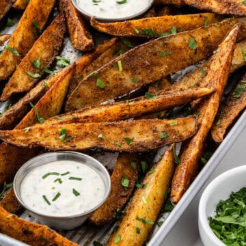 cup of ranch surrounded by seasoned copycat buffalo wild wings potato wedges
