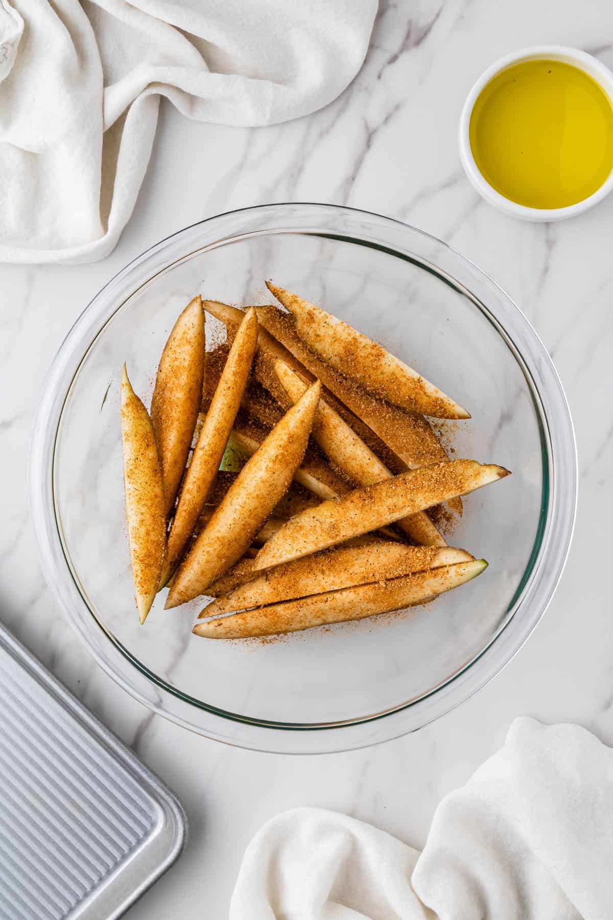 seasoned potato wedges in clear bowl