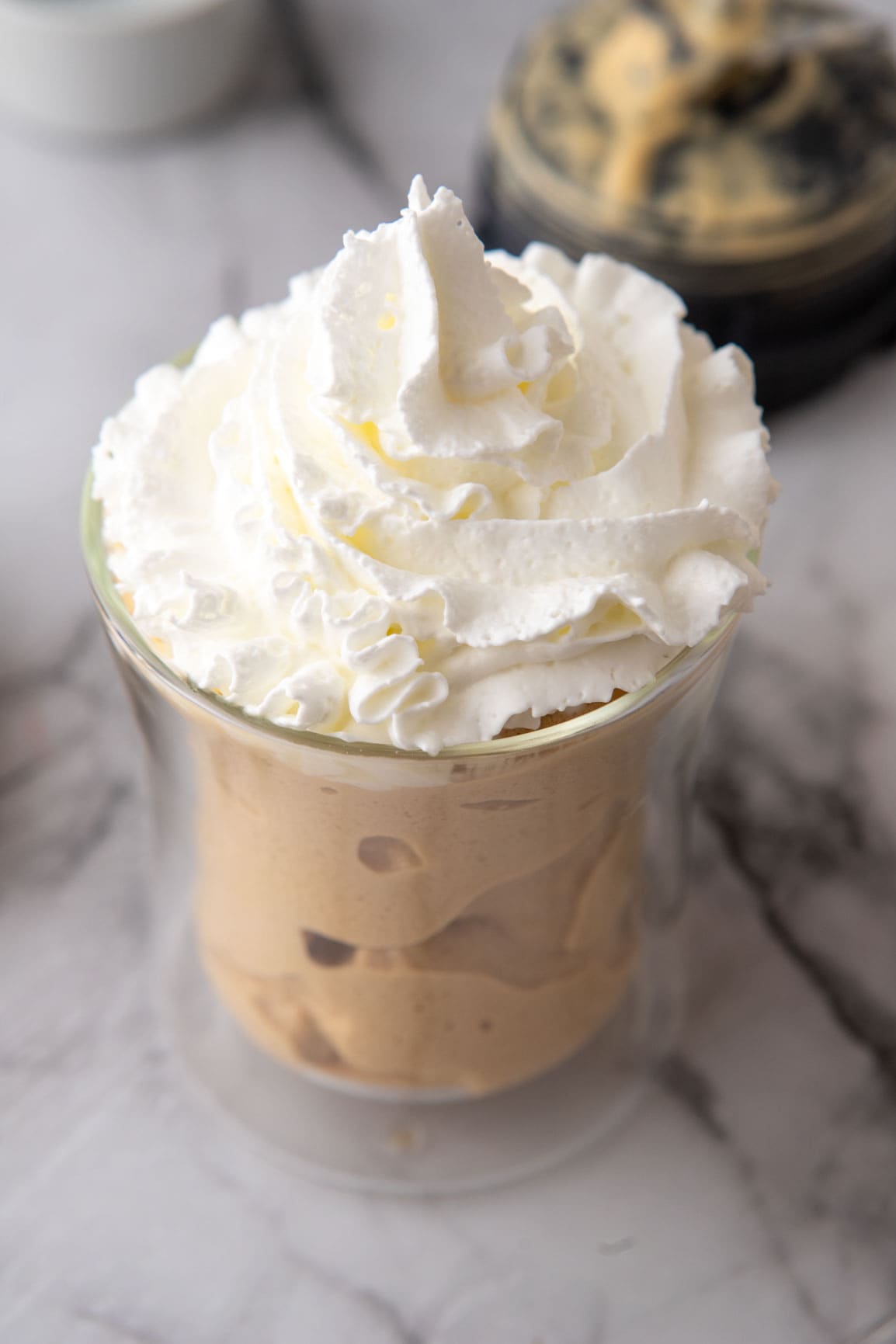 overhead shot of whipped cream on top of the dunkin frozen coffee recipe