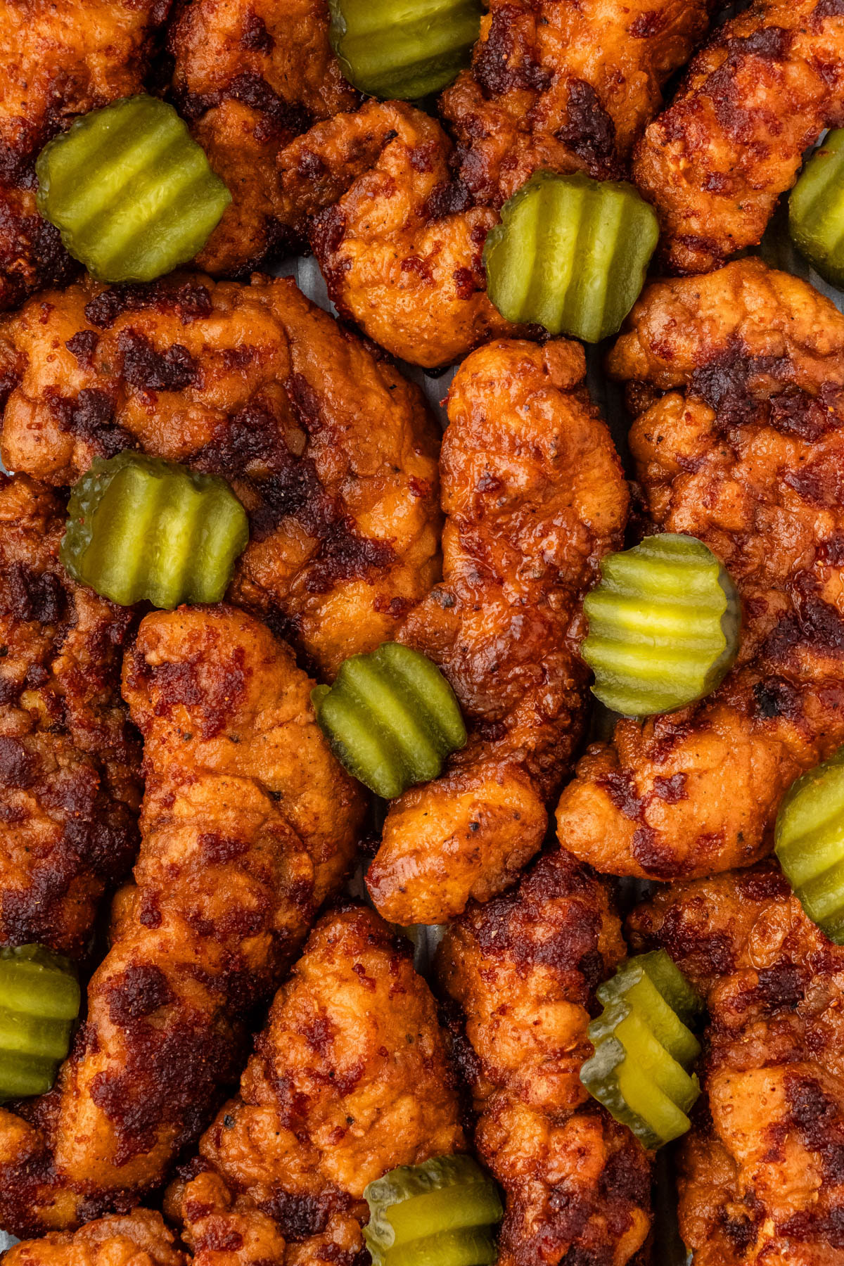 close up of KFC Nashville hot chicken recipe with pickles on it