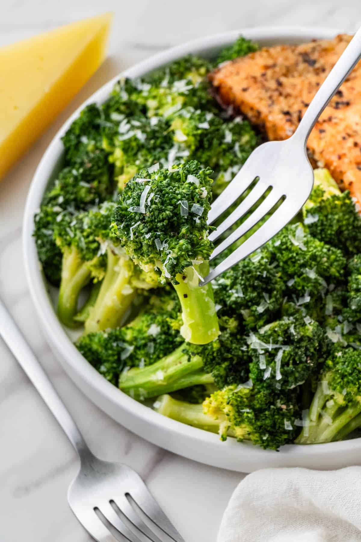 Longhorn Steakhouse Broccoli recipe with cheese with silver fork and salmon