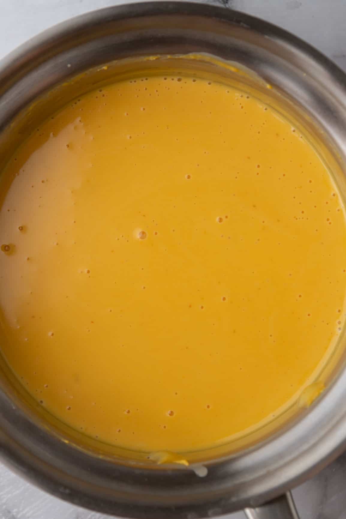cheese sauce ingredients being combined in a saucepan