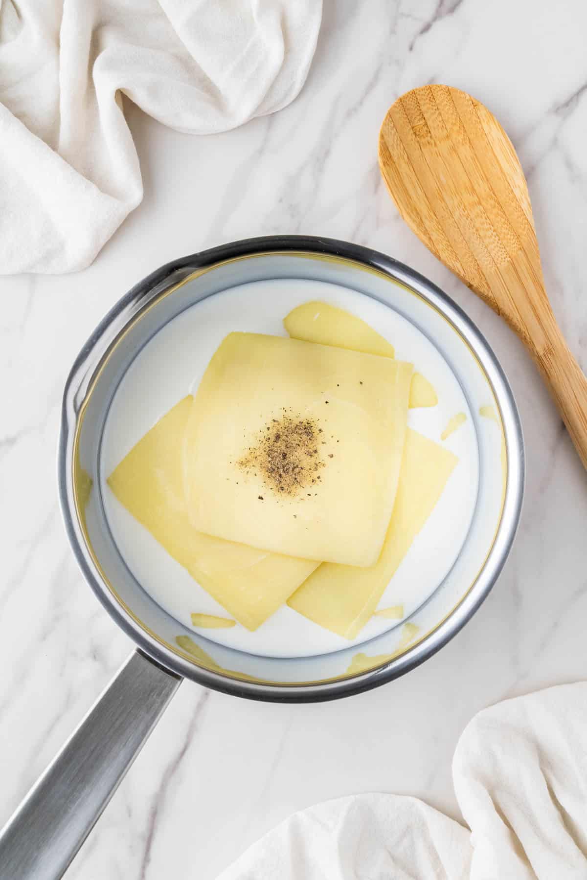 American cheese sliced in milk on the stove