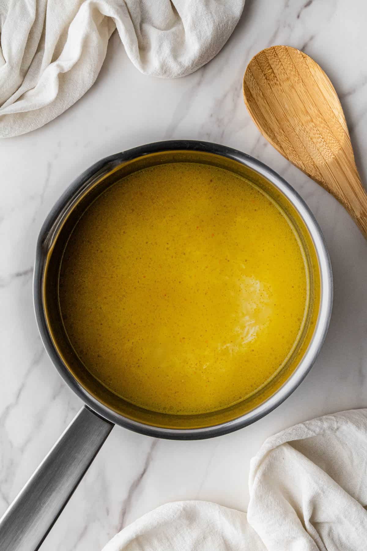 rice with seasonings in a pot smothered in broth