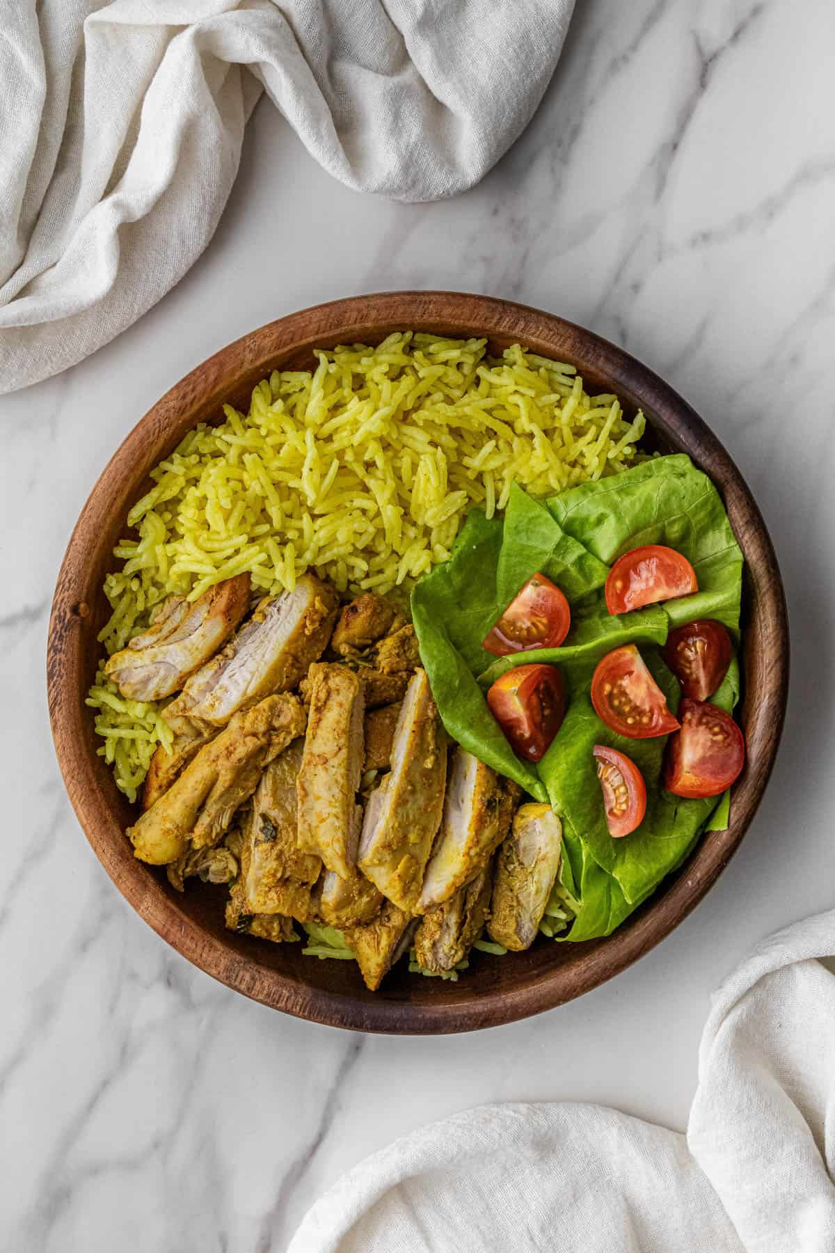 chicken and vegetables over rice in a bowl