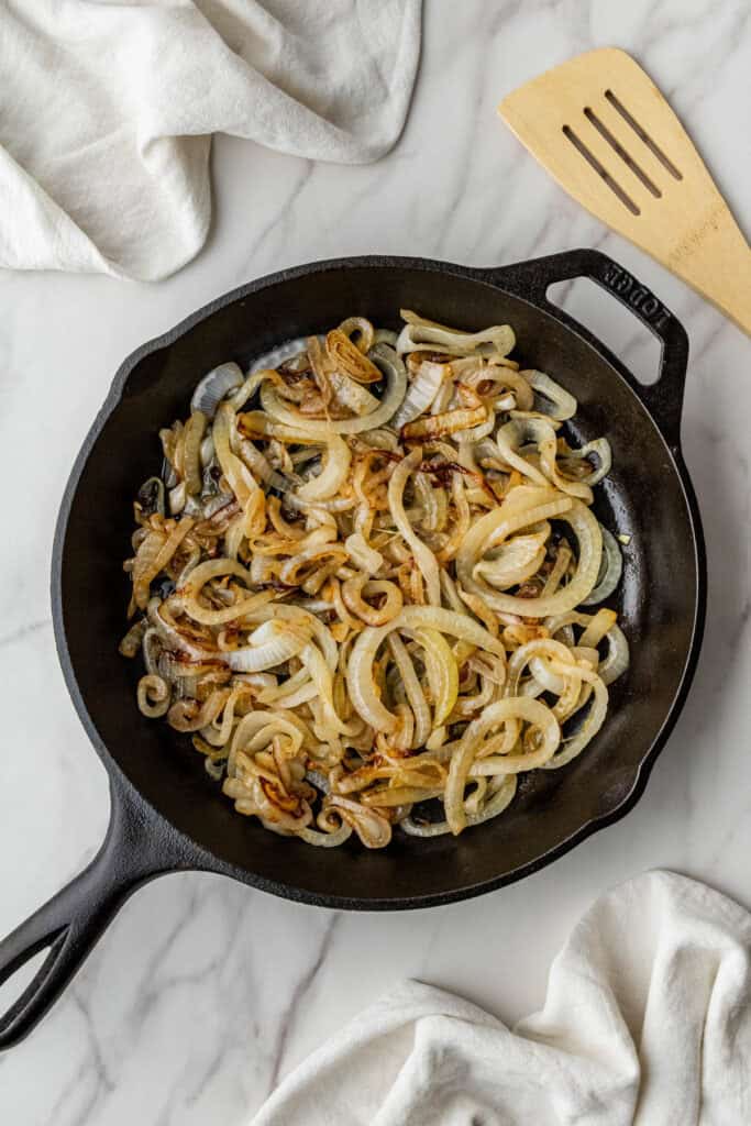 onions caramelizing in a cast iron skillet