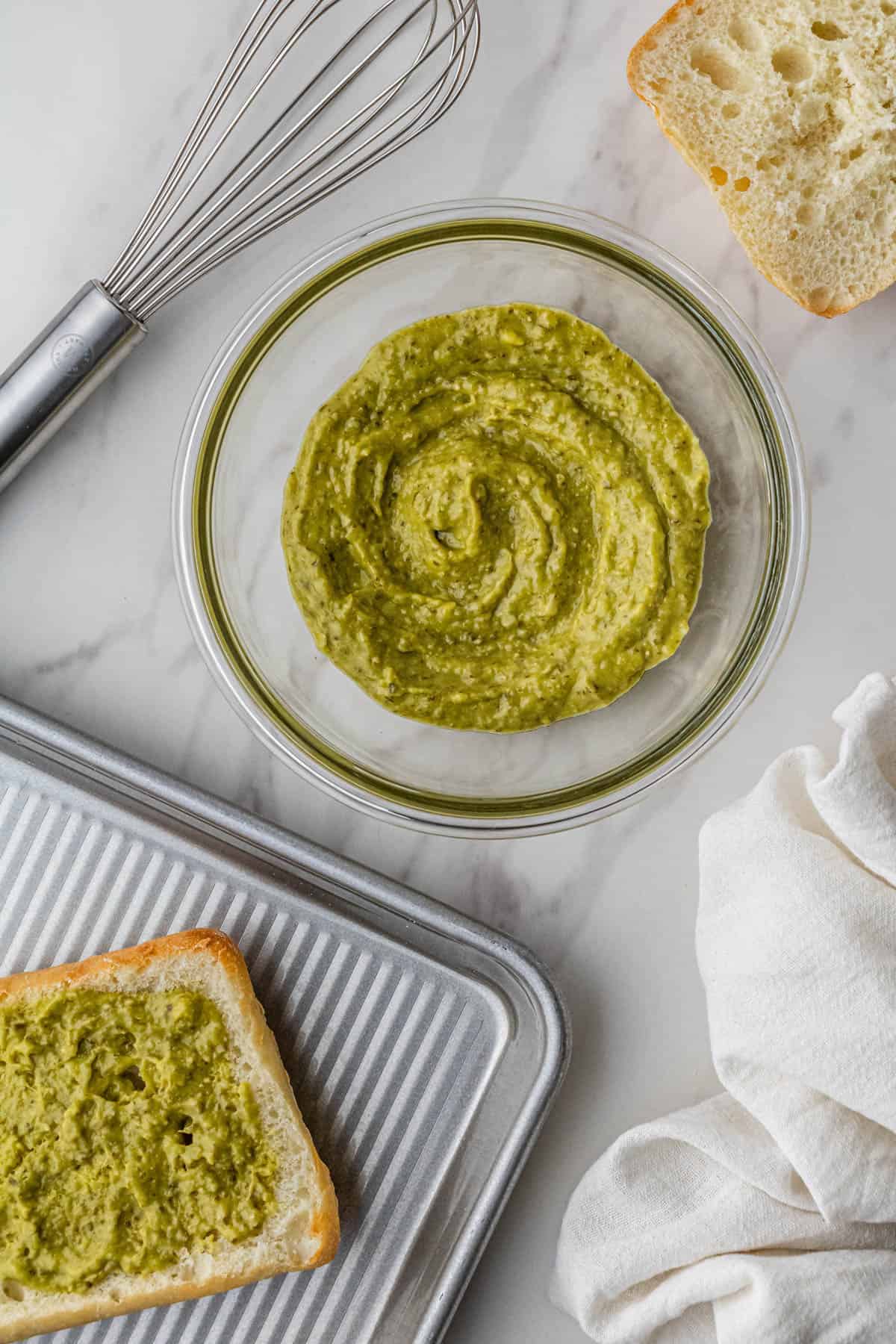basil and mayo mixed together in clear bowl