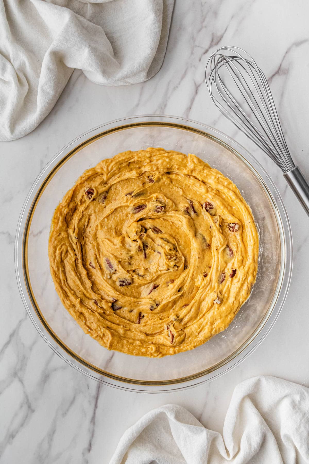 mixed batter ingredients in clear bowl
