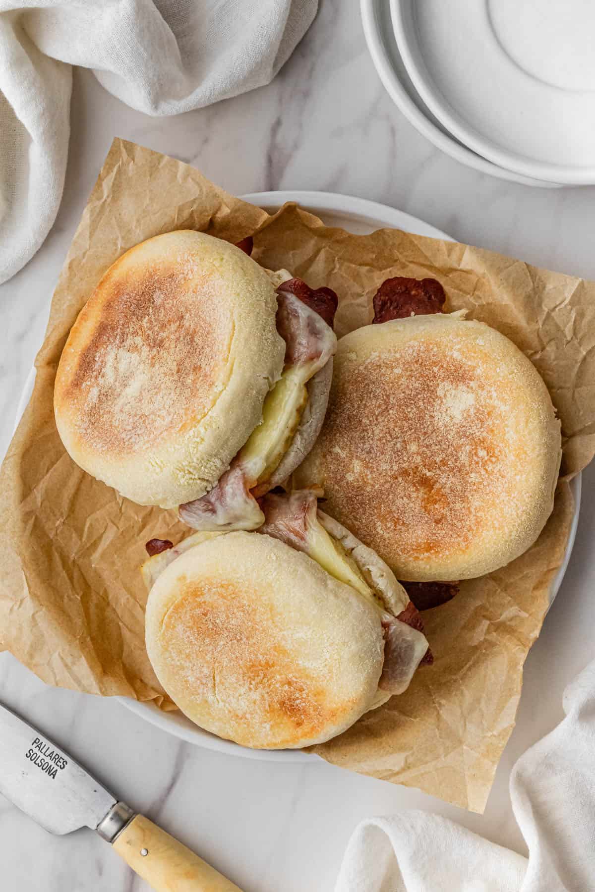 three Starbucks turkey bacon sandwich recipe on plate with brown paper