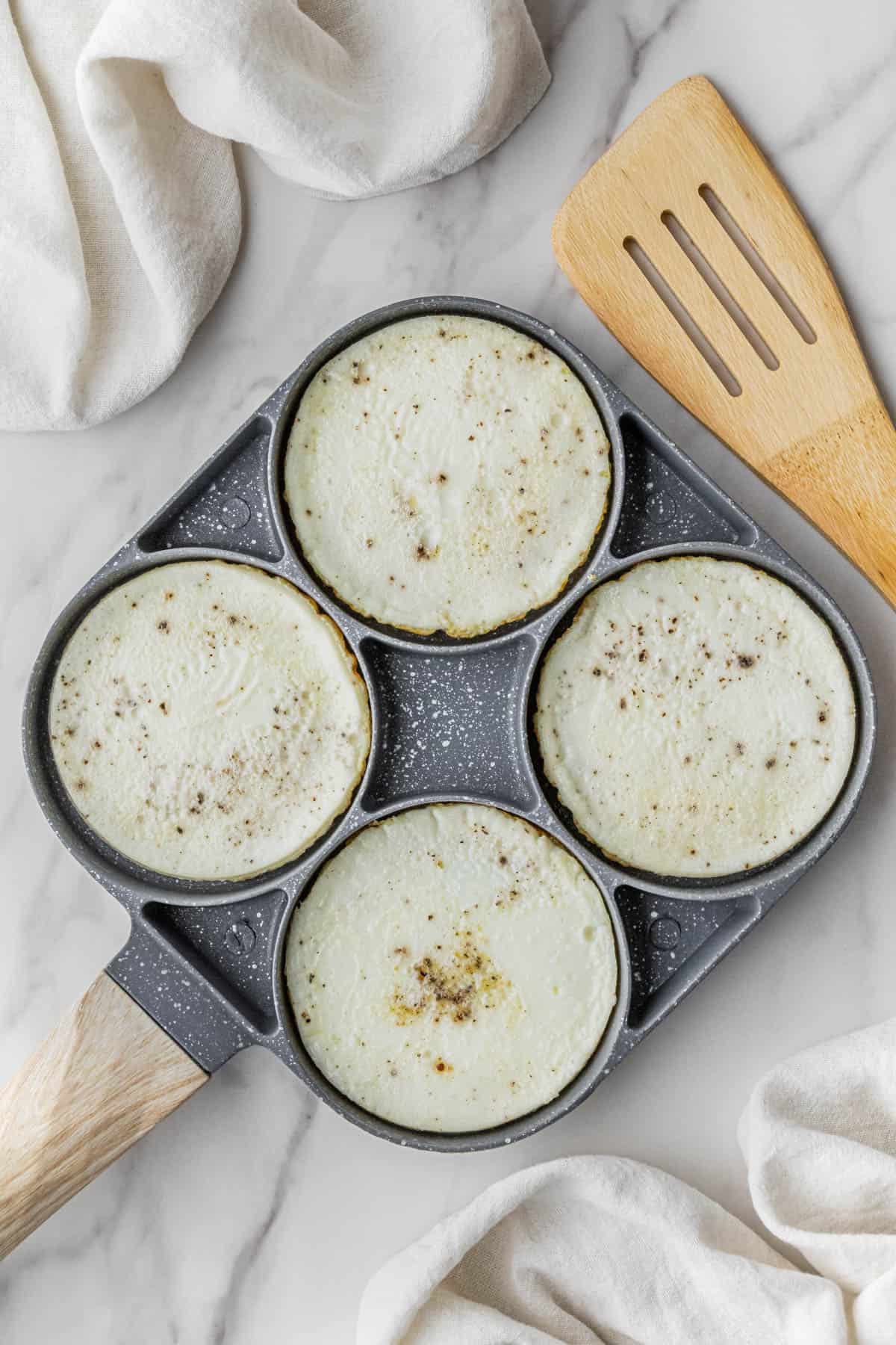 egg whites cooking in circle egg pan