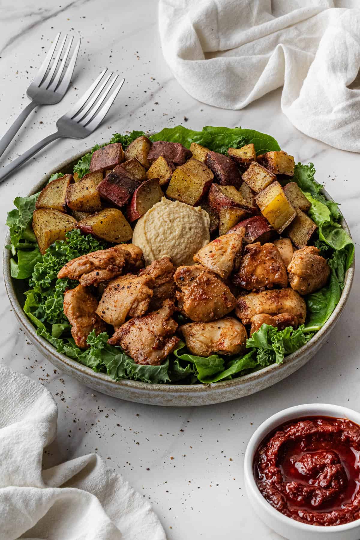 Cava Honey Harissa Chicken recipe on a bed of greens