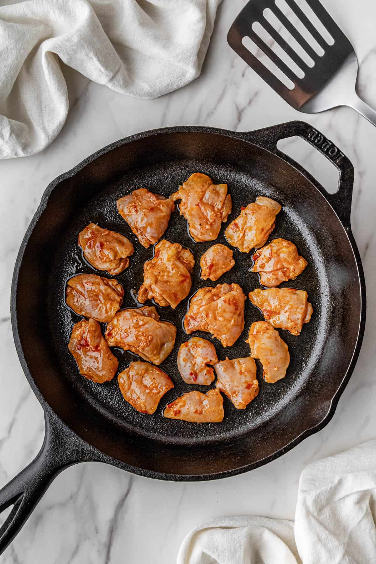 raw meat searing in a skillet