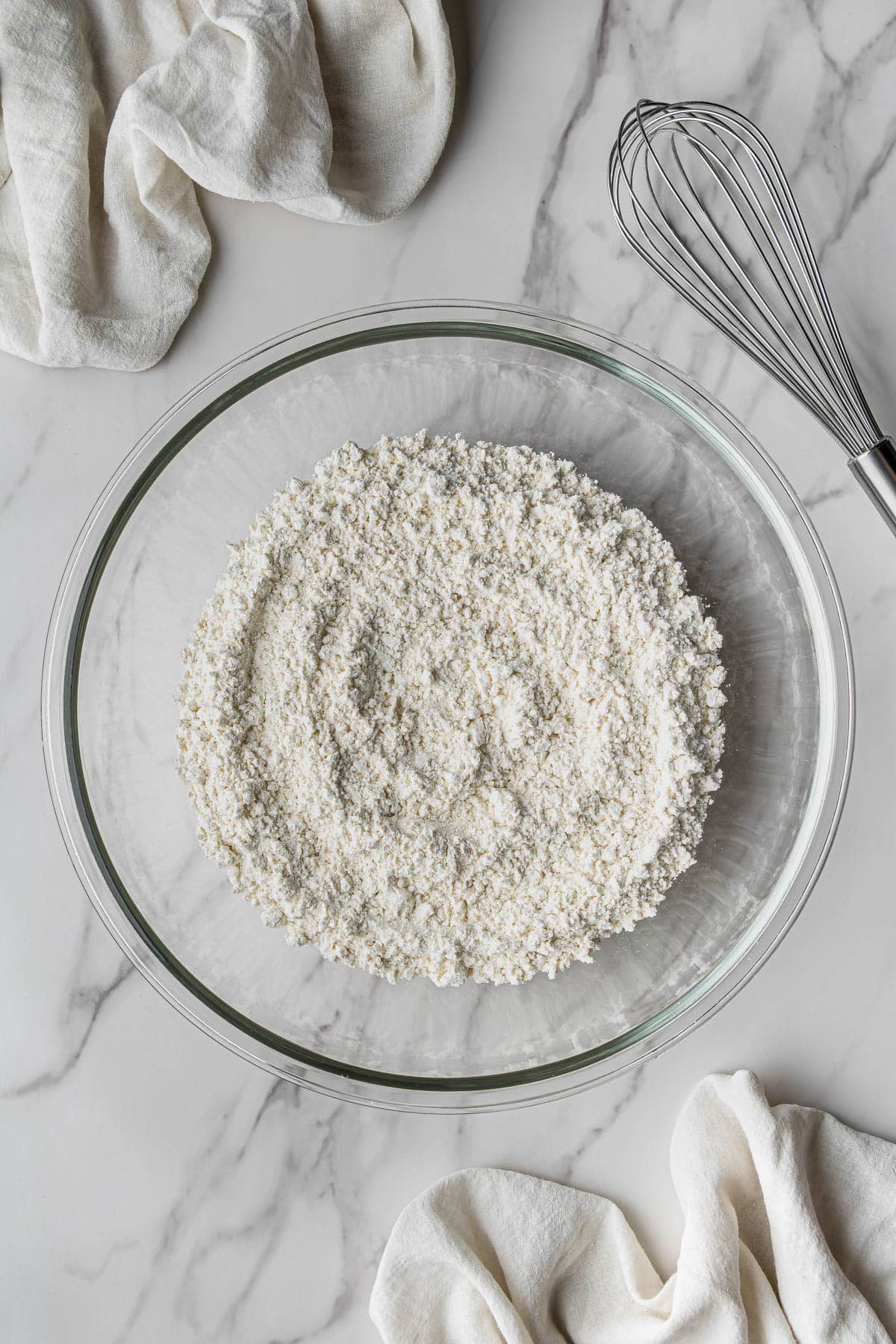 overhead view of flour in clear bowl