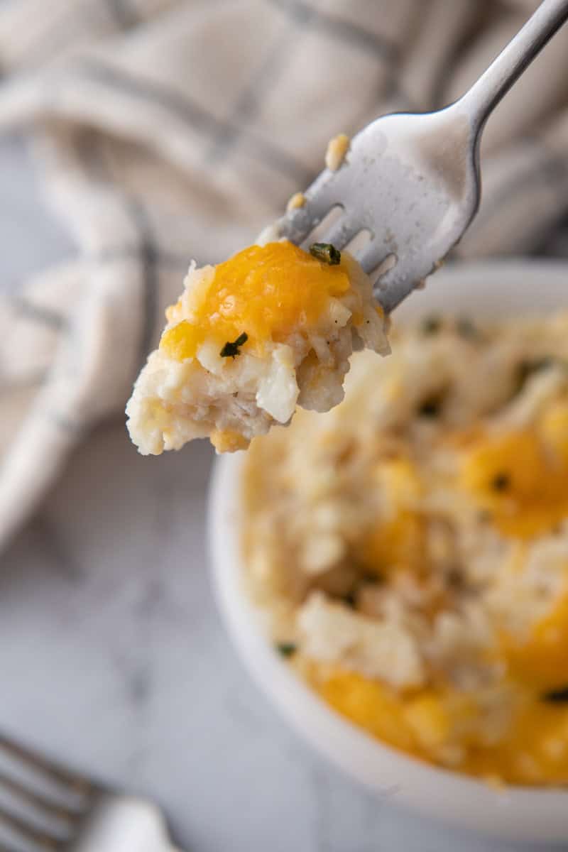 Cracker Barrel Cheesy Hash Brown Recipe crock pot in a bowl with a fork
